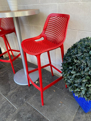 2 Red Siesta Air Bar Stools + Round Cruiser Table